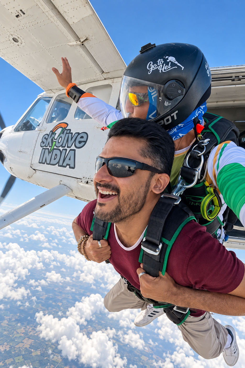 Tandem passenger and instructor beside a skydiving plane above the clouds in India